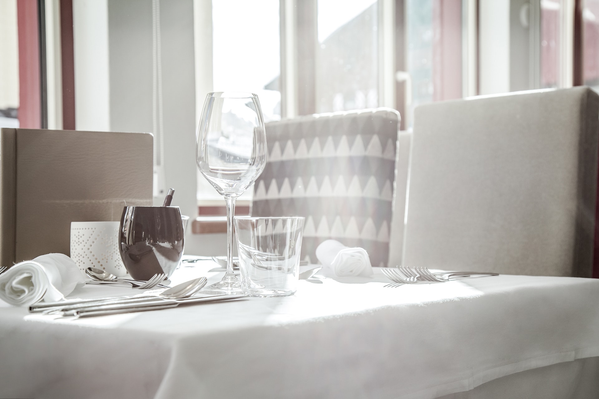 Elegant dining setup with pristine tableware bathed in natural light.