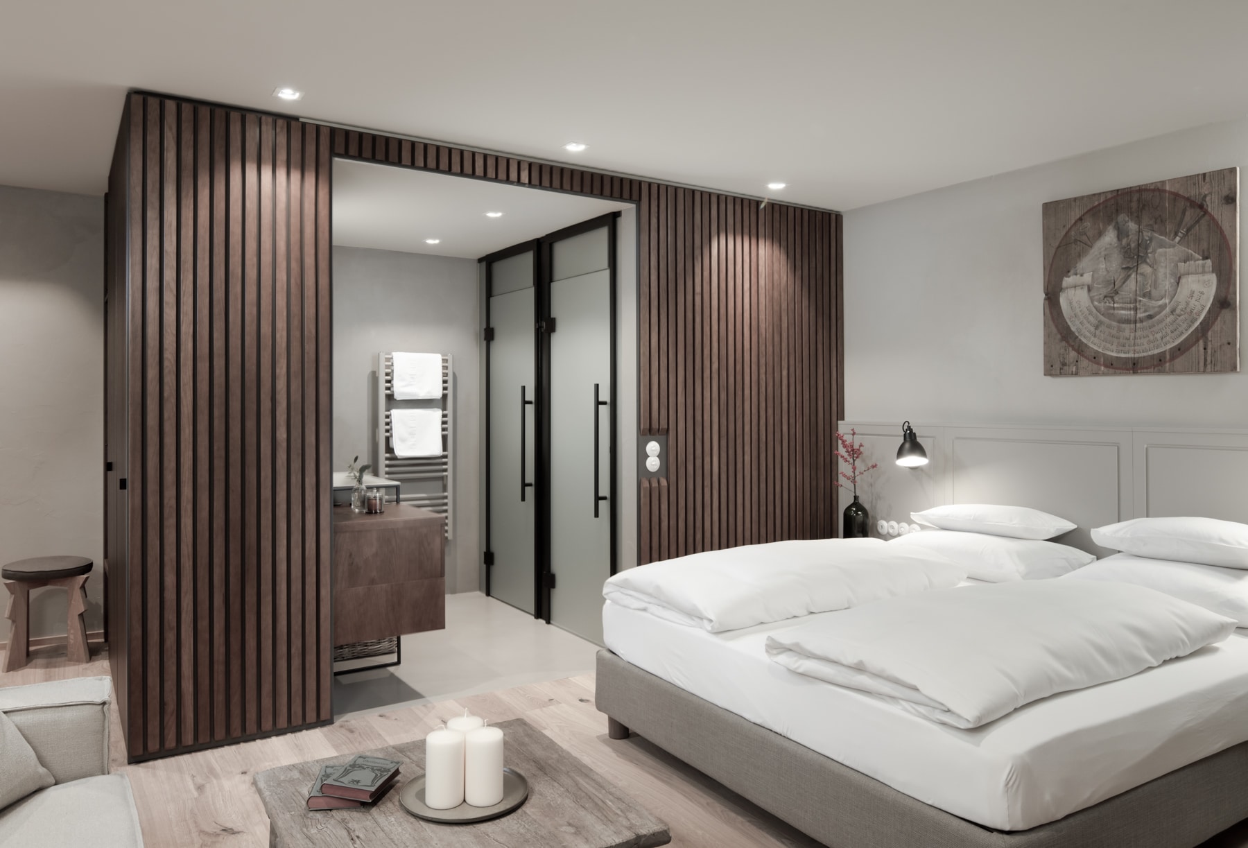 Elegant modern bedroom with a sleek design featuring a comfortable bed, sliding wooden panels leading to an en-suite bathroom, and harmonious neutral tones for a relaxing atmosphere.